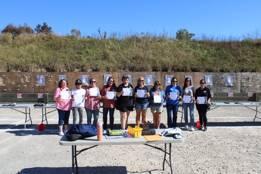 women's firearm safety class at the range with their certificates